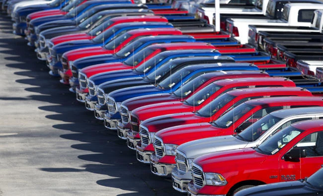 Dodge Ram pickup trucks are on display on the lot at Landmark Dodge Chrysler Jeep RAM in Morrow, Georgia, in this file photo. The US government is suing Fiat Chrysler, alleging that some diesel pickup trucks and Jeeps cheat on emissions tests. (AP Photo/John Bazemore, File)