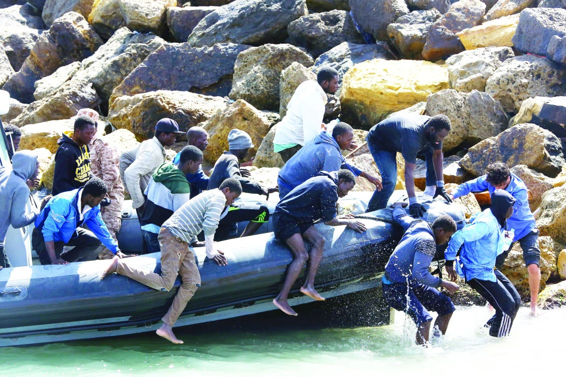 Illegal migrants from Africa arrive on shore after being rescued by Libyan coast guards rescued at sea, off the coastal town of Tajoura, 15 kilometers east of the capital Tripoli on Tuesday. (AFP)