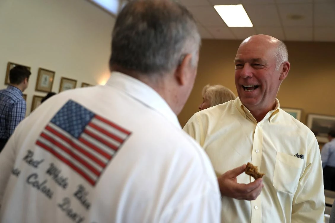 Republican congressional candidate Greg Gianforte talks with a supporter during a campaign meet and greet at Lambros Real Estate on May 24, 2017 in Missoula, Montana. (AFP)