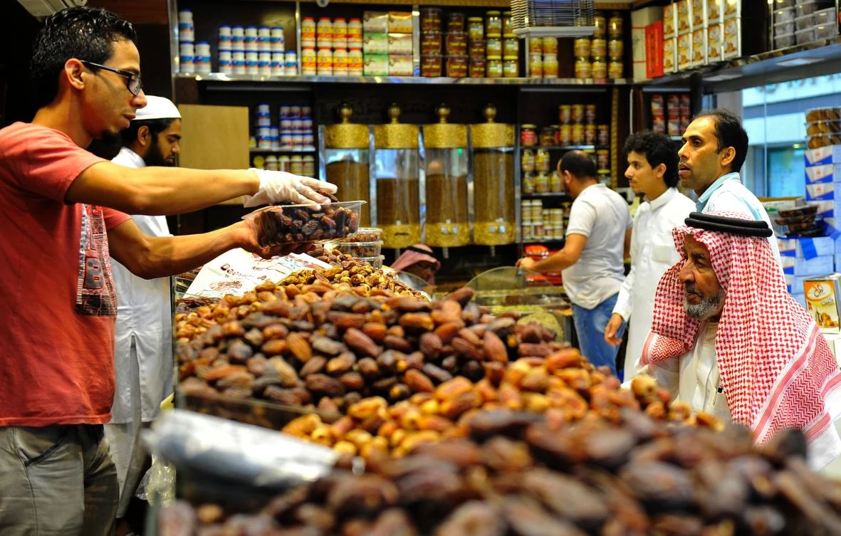 Shoppers buy dates at a shop in Jeddah ahead of the fasting month of Ramadan. (AFP)