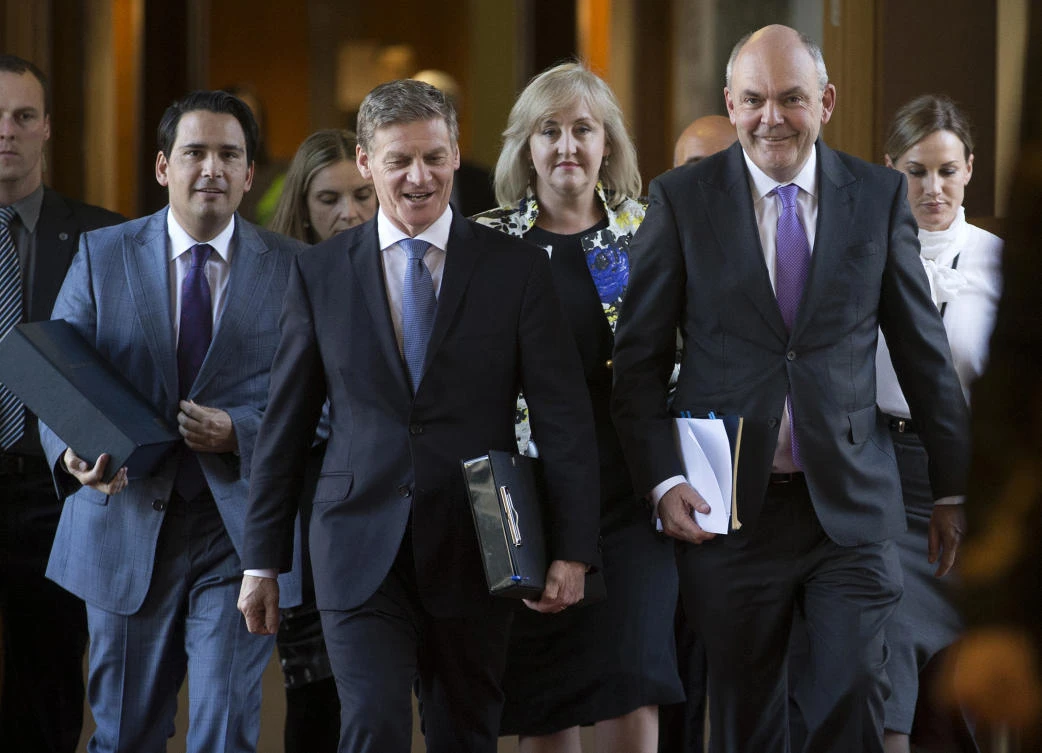 New Zealand Finance Minister Steven Joyce walks with Prime Minister Bill English to present his budget in Parliament. (AP)