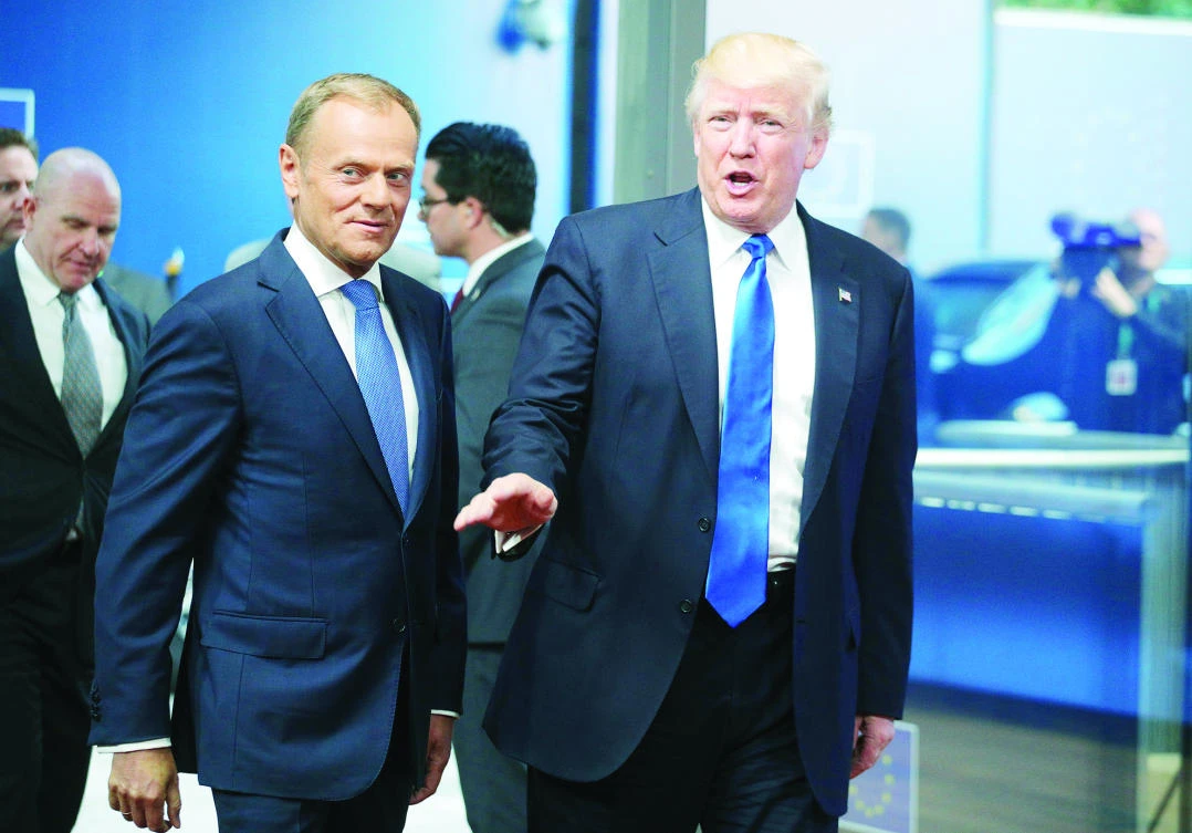 US President Donald Trump is greeted by European Council President Donald Tusk as he arrives at the Europa building in Brussels on Thursday. (AP)