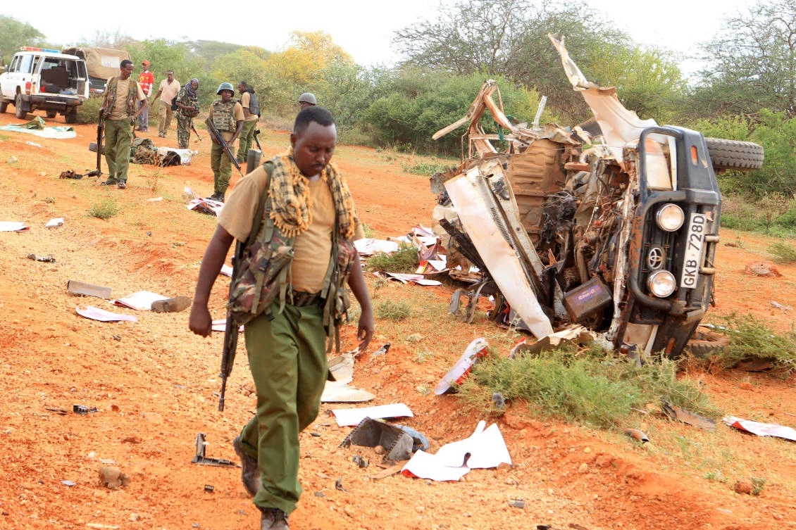 A Kenyan security person walk past a police vehicle damaged by a blast which killed Kenyan police officers at the Garissa county, eastern Kenya, on Wednesday. (Reuters)
