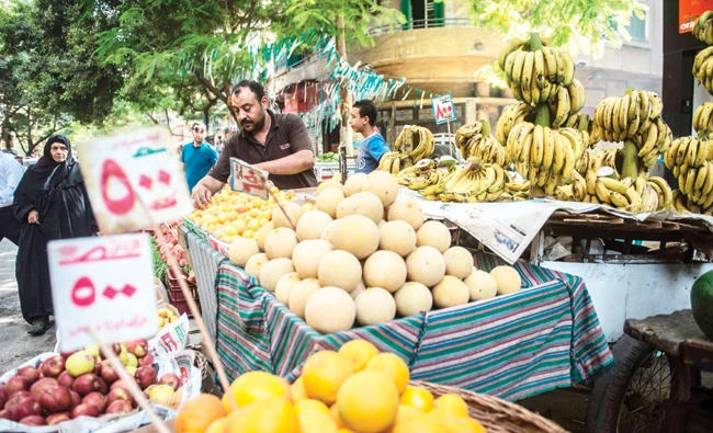 A fruit vendor waits for customers in Cairo. (AFP)