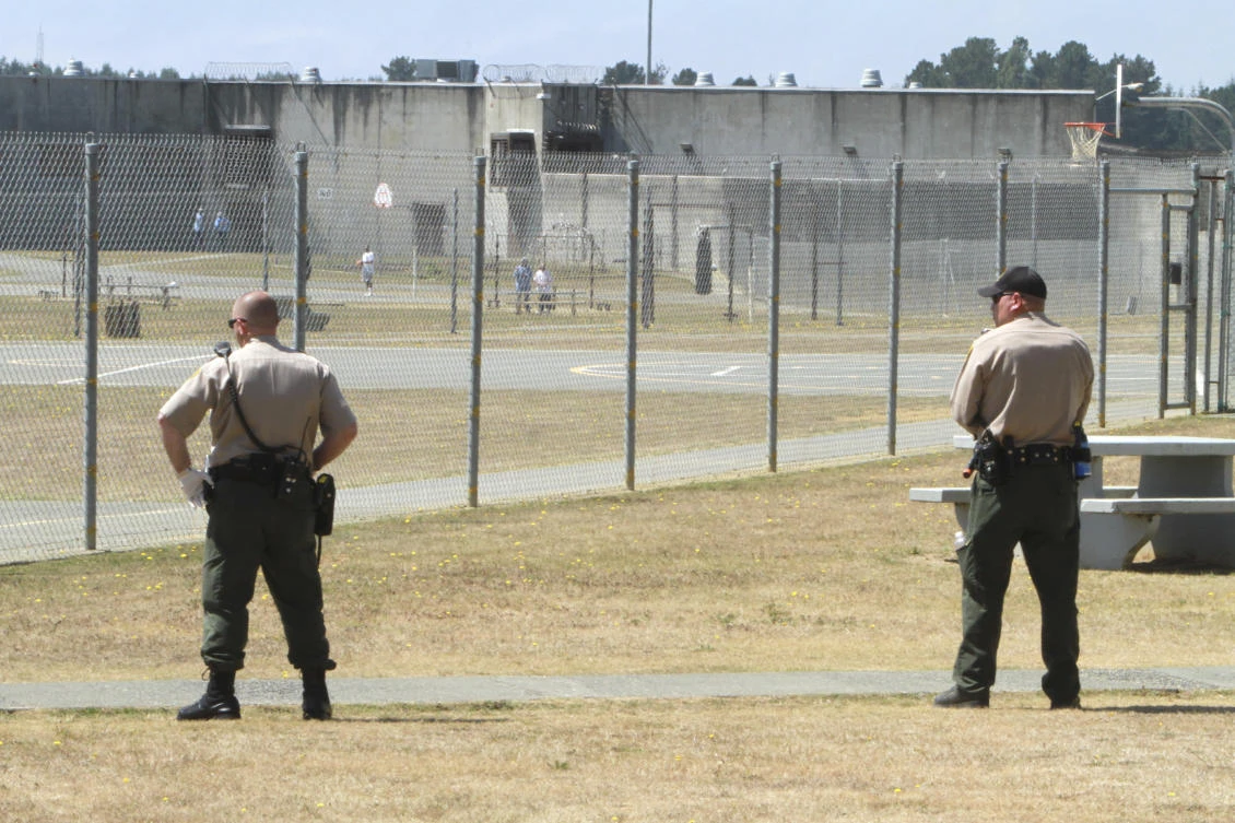 In this Aug. 17, 2011 file photo, correctional officers keep watch on inmates in the recreation yard at Pelican Bay State Prison near Crescent City, California. (AP Photo/Rich Pedroncelli, File)