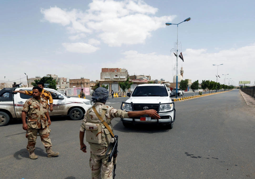 An army soldier gestures as a convoy of the United Nations Special Envoy for Yemen, Ismail Ould Cheikh Ahmed, passes outside Sanaa airport, Yemen on May 22, 2017. (REUTERS/Khaled Abdullah)