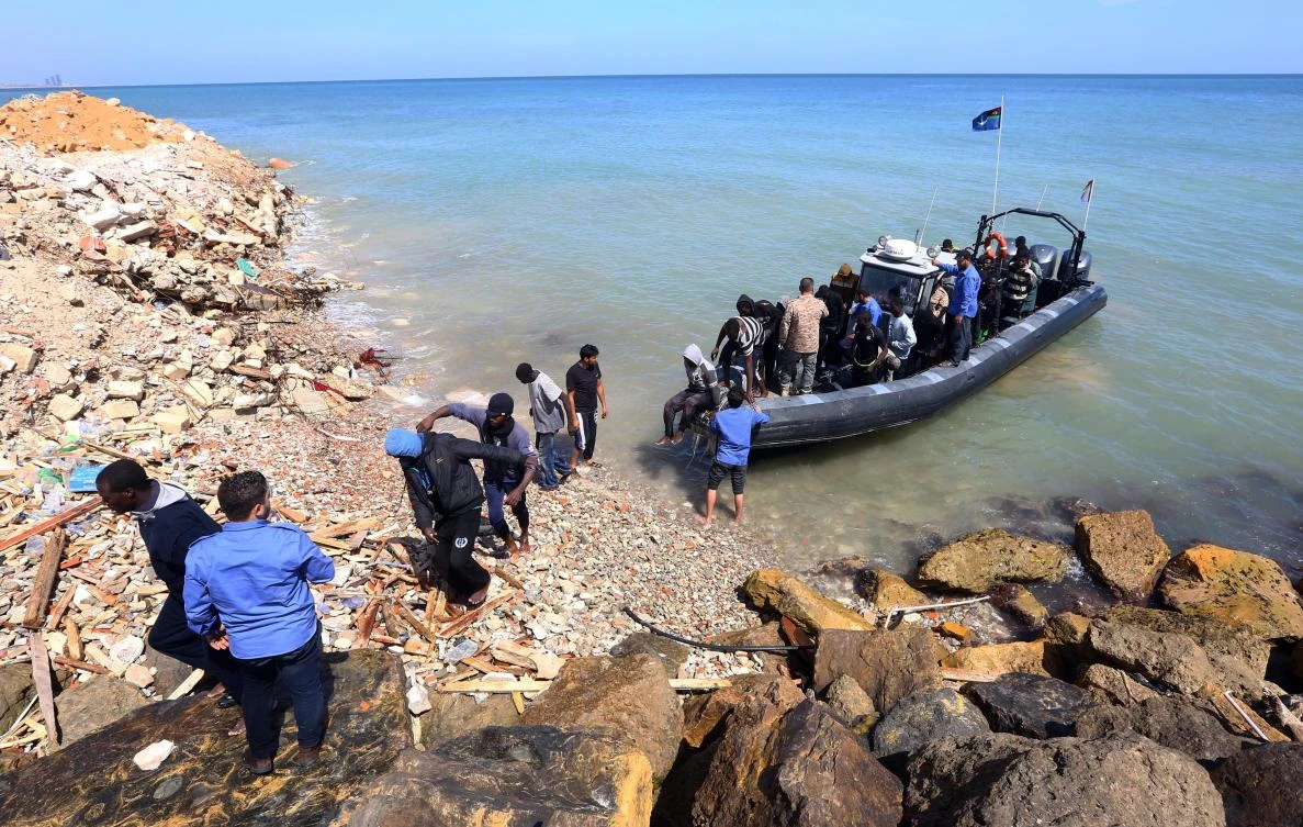 Illegal migrants from Africa arrive on shore after being rescued by Libyan coast guards rescued at sea, off the coastal town of Tajoura, 15 km east of Tripoli on Tuesday. (AFP)