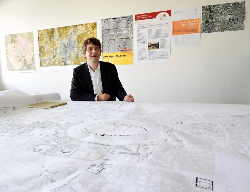 Urban planner Christoph Wessling gives explanations on a map showing Syria's town of Aleppo at the university in Cottbus in this May 17 photo. (AFP)