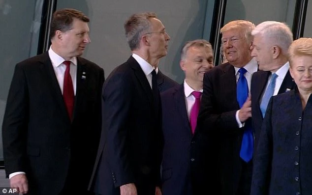 Shove it: Trump's anger about being stuck at the back of a crowd when he needs to be an 'alpha' led to him shoving the leader of Montenegro on Thursday, a body language expert said. (AP)