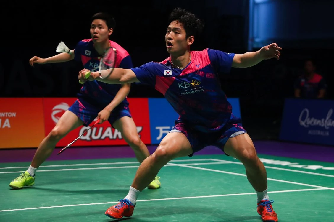 South Korean Choi Solgyu, right, hits a return during the men's doubles Sudirman Cup match with Seung Jae Seo against Bodin Issara and Dechapol Puavaranukroh of Thailand (not pictured) at the Gold Coast Sports Center on Saturday. (AFP)