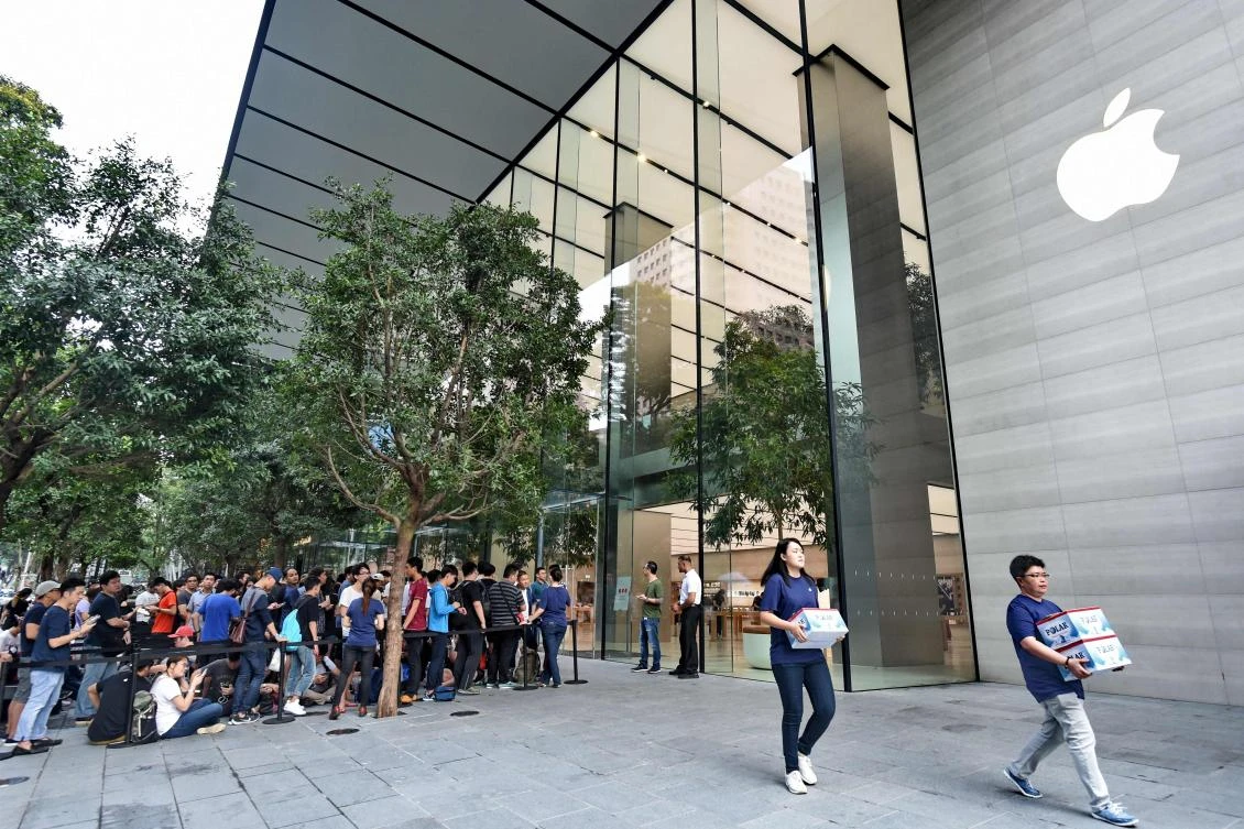 People queue outside the Apple store in the Orchard shopping district during its opening day in Singapore on Sunday. (AFP)