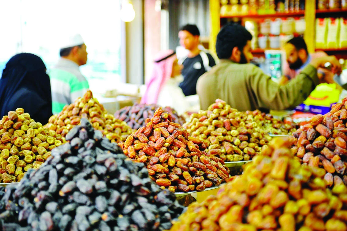 People buy dates — traditionally eaten to break the Ramadan fast — at a shop in Jeddah. (AFP)