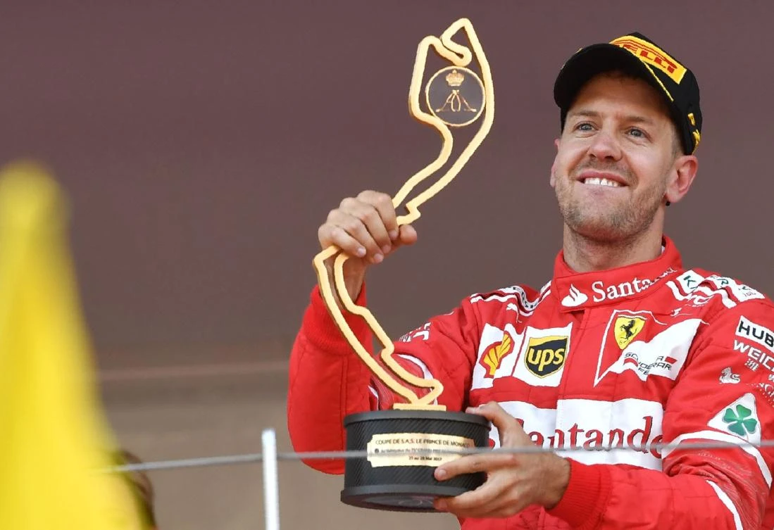 Ferrari's German driver Sebastian Vettel holds his trophy as he celebrates on the podium after winning the Monaco Formula 1 Grand Prix at the Monaco street circuit, on Sunday in Monaco. (AFP)