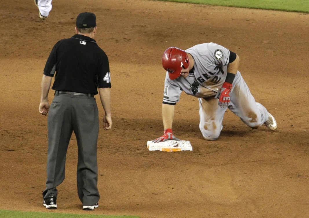 Los Angeles Angels' Mike Trout grimaces after stealing second during the fifth inning of an interleague baseball game against the Miami Marlins Sunday in Miami. Trout injured his thumb on the play. (AP)