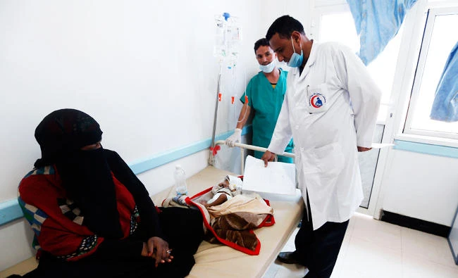 A Yemeni mother sits near her child suspected of being infected with cholera receiving treatment at a hospital in Sanaa, in this May 25, 2017 photo. (AFP)
