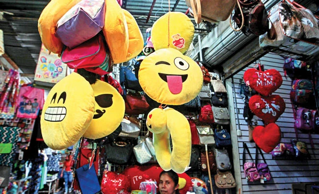 A woman sells emoji cushions at the Oriental market in Managua, Nicaragua, on in this May 19 photo. (Reuters)