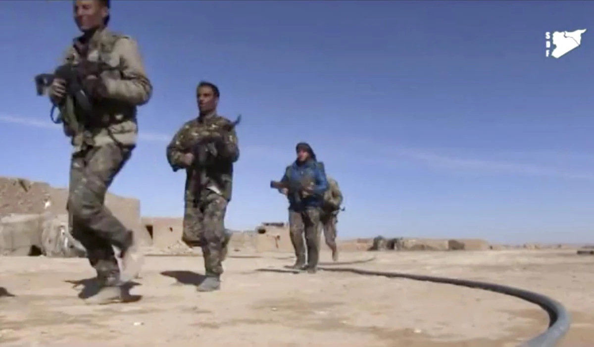 This March 6, 2017 file frame grab from a video provided by the Syria Democratic Forces (SDF) shows fighters during fighting with Daesh militants in Raqqa's eastern countryside, Syria. (Syria Democratic Forces, via AP, File)
