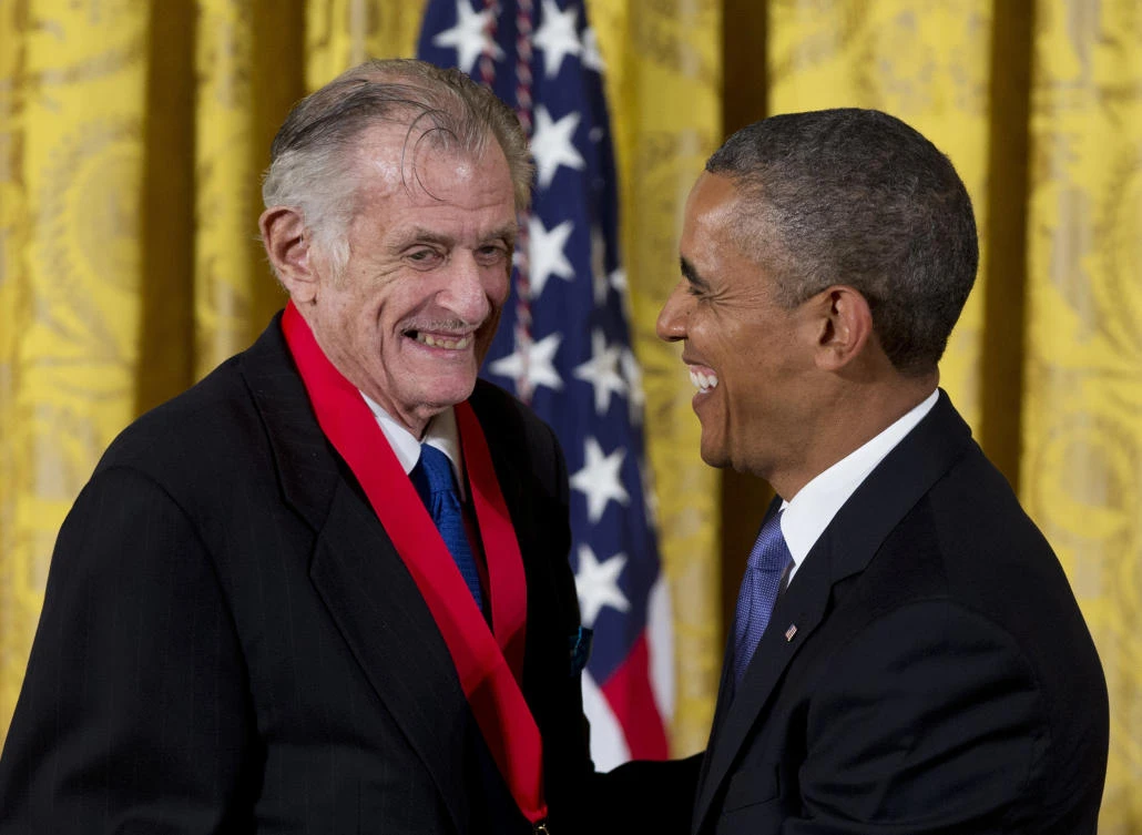 In this July 10, 2013, file photo, President Barack Obama laughs with Frank Deford as he awards him the 2012 National Humanities Medal during a ceremony in the East Room of White House in Washington. Award-winning sports writer and commentator Deford has died. He was 78. (AP