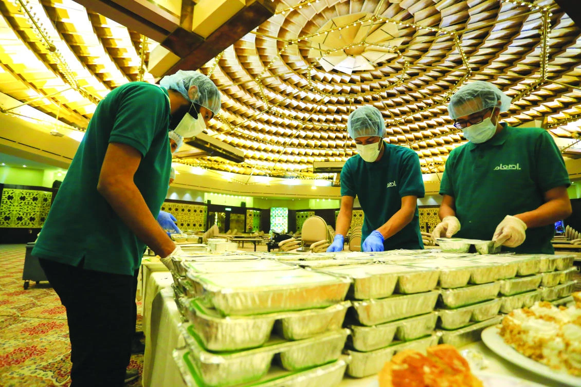 Volunteers gather to prepare for distribution of food to needy people for iftar and sahoor during Ramadan.
