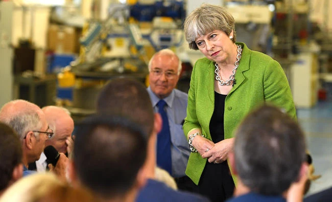 Britain's Prime Minister Theresa May listens during a question and answer session during a general election campaign rally at Cross Manufacturing in Bath, southwest England, on Wednesday, as campaigning continues in the build up to the general election on June 8. (AFP / POOL / Leon Neal)