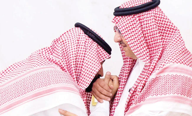 Crown Prince Mohammed bin Salman, left, kisses the hand of Prince Mohammed bin Naif at Al-Safa Palace in Makkah on Wednesday. (SPA)