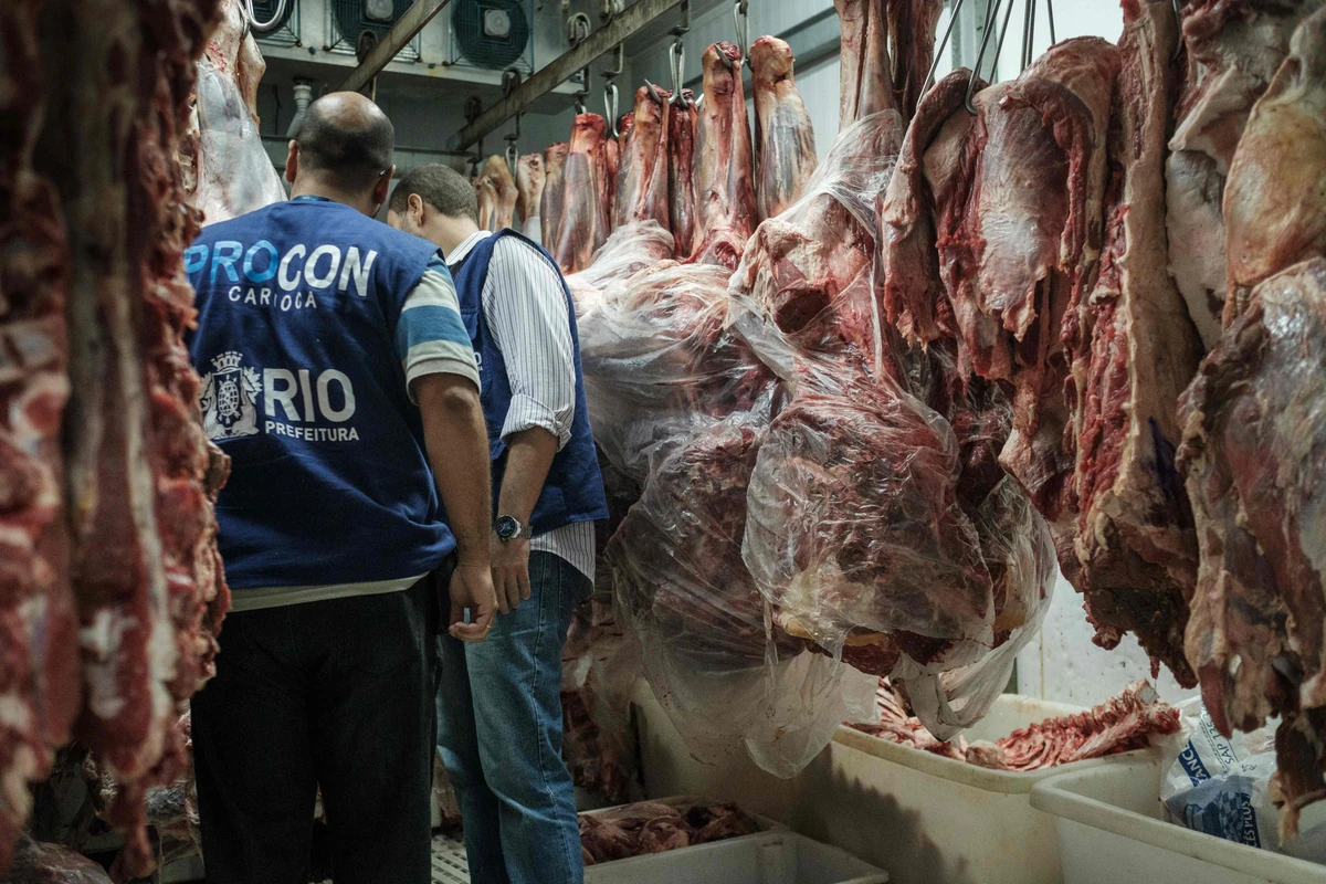 This file photo taken on March 24, 2017 shows the staff of Rio de Janeiro state's consumer protection agency, PROCON, inspecting meat products in the cold storage room at a supermarket in Rio de Janeiro, Brazil. The United States announced Thursday a halt to all imports of fresh beef from Brazil, the world's second-largest producer, citing "recurring" food safety concerns. (AFP)