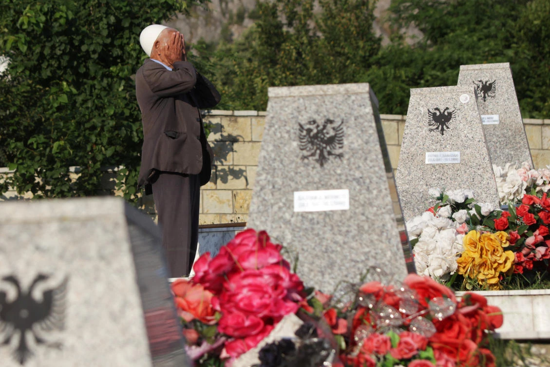 A man prays at the martyrs' cemetery on Eid al-Fitr in Racak, Kosovo, June 25, 2017. REUTERS/Hazir Reka