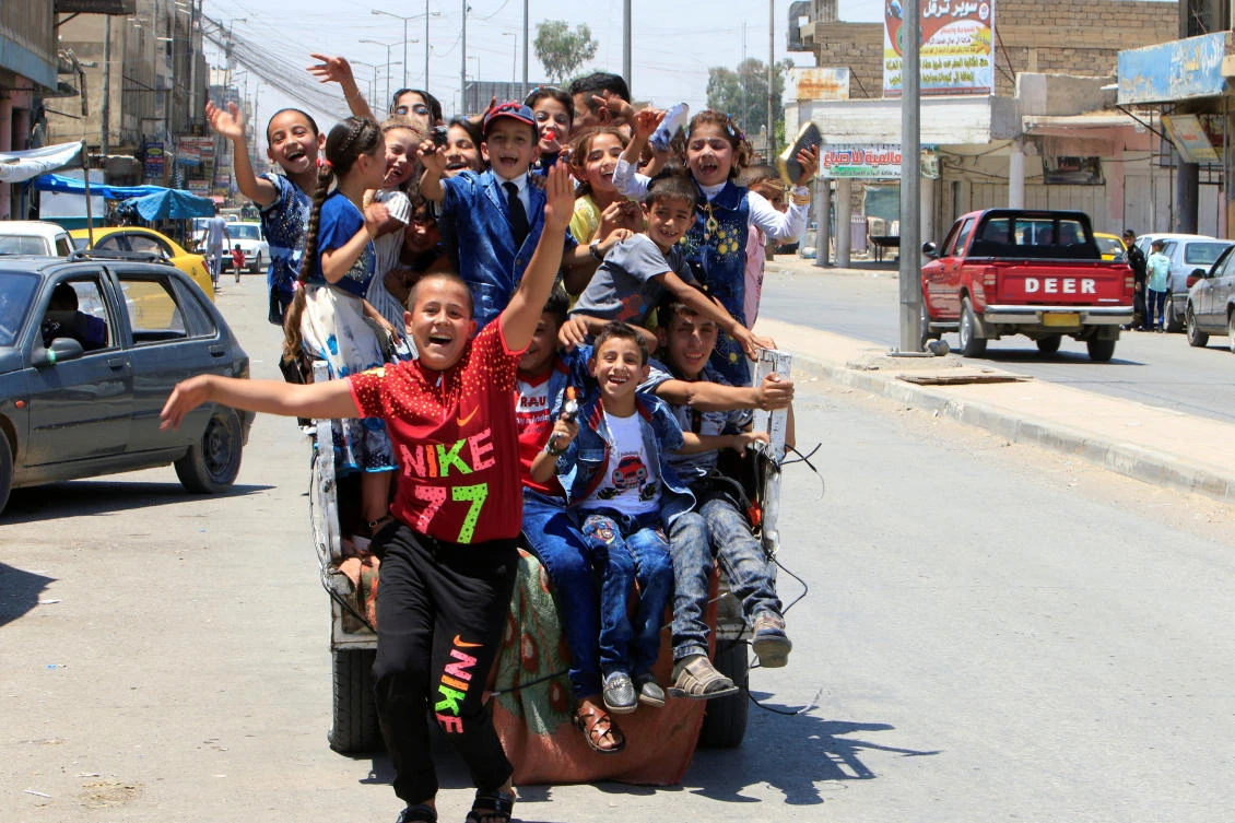 Iraqi children enjoy riding a mini car as they celebrate Eid al-Fitr, in Mosul, Iraq June 25, 2017. REUTERS/Alaa Al-Marjani