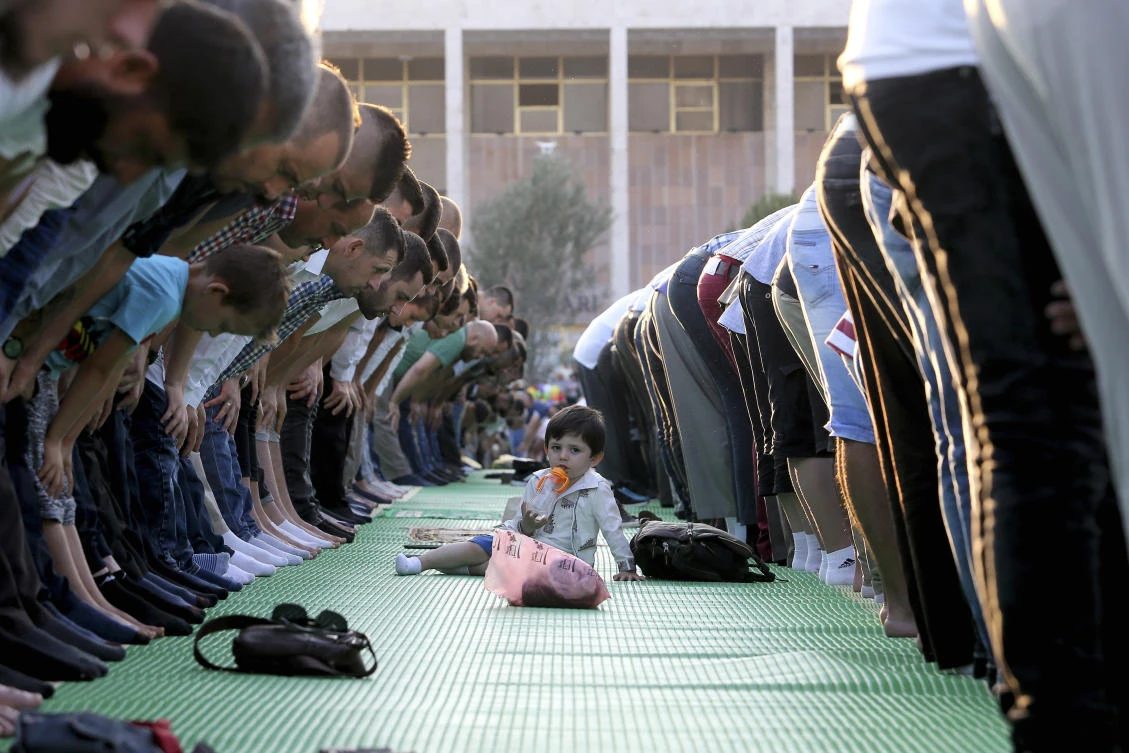 Muslims pray to celebrate the end of the Muslim fasting month of Ramadan at the capital Tirana's recently renovated Skanderbeg Square Sunday, June 25, 2017. (AP Photo/Hektor Pustina)
