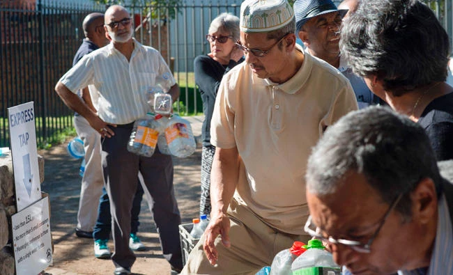 People queue up to collect drinking water from taps that are fed by a spring in Newlands in Cape Town in this May 15 file photo. (AFP)
