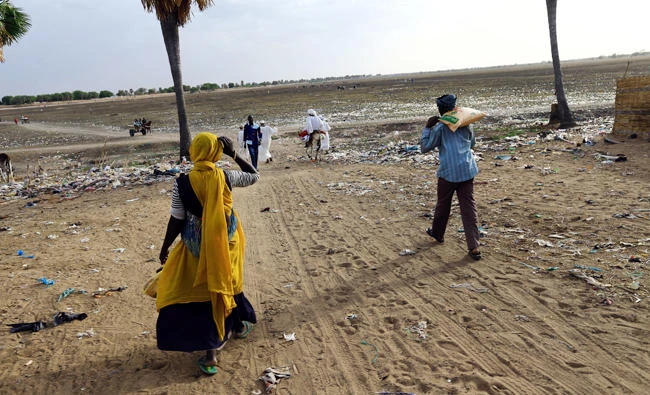 Refugees walk toward the border with Central African Republic in Sudan’s Um Dafuq on Monday. (Reuters)