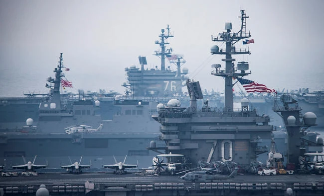 US Navy aircraft carriers USS Carl Vinson, right, and USS Ronald Reagan sail with their strike groups and Japanese naval ships during training in the Sea of Japan, on Thursday. (Reuters)