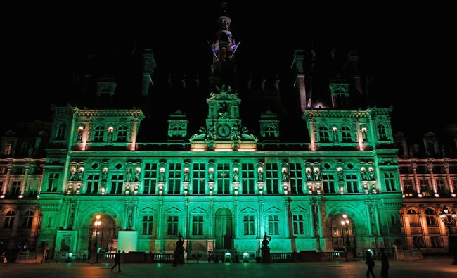 A picture taken on June 1, 2017, shows the City Hall of Paris illuminated in green following the announcement by US President Donald Trump that the United States will withdraw from the 2015 Paris accord and try to negotiate a new global deal on climate change. (AFP / GEOFFROY VAN DER HASSELT)