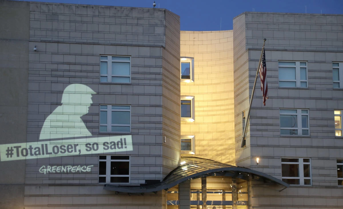 A Greenpeace banner showing US President Donald Trump and the slogan ‘#TotalLoser, so sad!’ is projected on the facade of the US Embassy in Berlin, Germany, on Friday. Trump declared Thursday he was pulling the US from the landmark Paris climate agreement, striking a major blow to worldwide efforts to combat global warming and distancing the country from its closest allies abroad. (AP Photo/Michael Sohn)