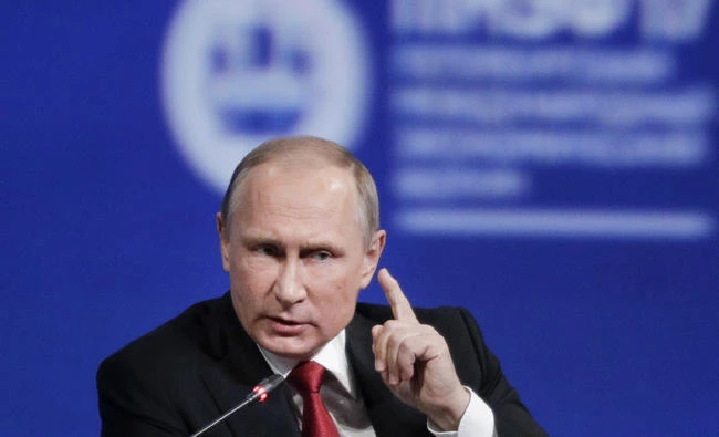 Russian President Vladimir Putin gestures as he speaks at the St. Petersburg International Economic Forum in St.Petersburg, Russia, on Friday. Putin says chemical attack in Syria was provocation to frame Assad. (AP Photo/Dmitry Lovetsky)