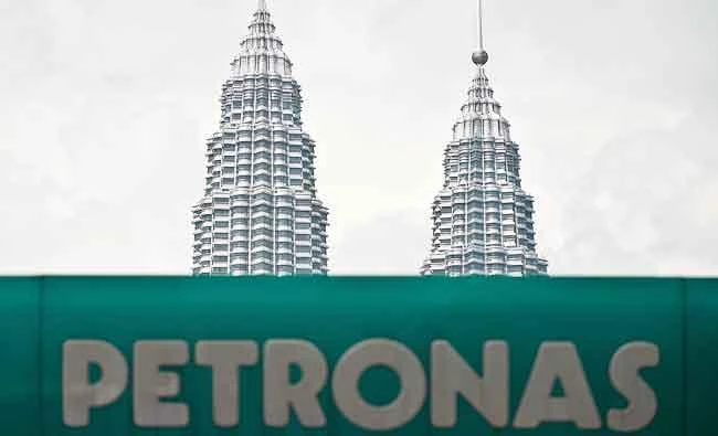 This file picture taken on August 13, 2014 Malaysia's iconic Twin Towers are seen behind a logo of Malaysian oil and gas company Petronas at a petrol station in Kuala Lumpur. (AFP)