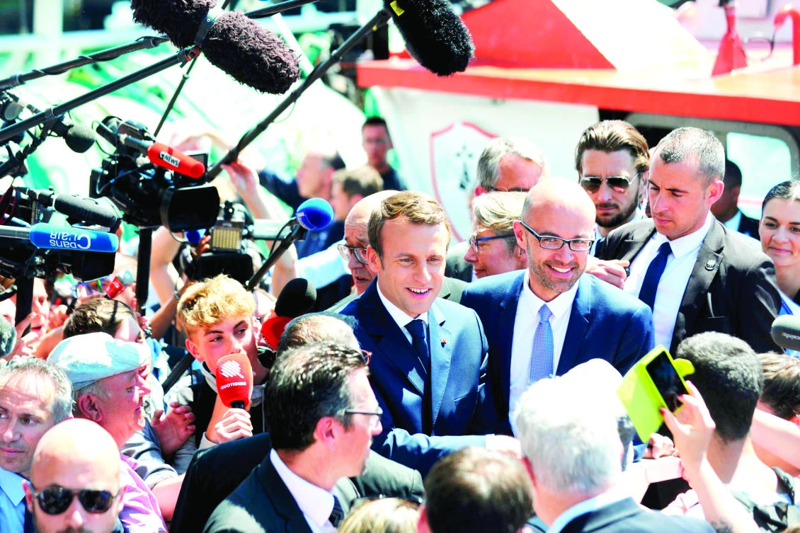 French President Emmanuel Macron, center, met supporters during a visit to the harbor of Lorient, western France, on Thursday. (AFP)
