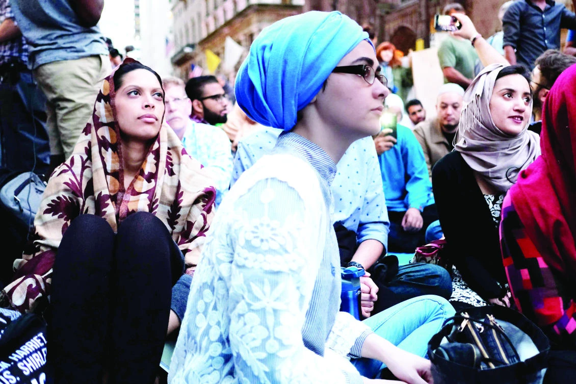 Muslims and supporters wait for Iftar during a demonstration to protest US President Donald Trump’s stand on Muslim and immigrants, near the Trump Tower in New York on Thursday. (AFP)