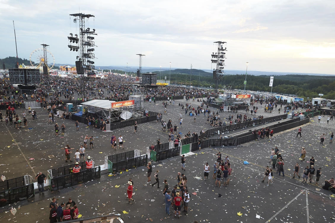 Visitors leave the music festival Rock am Ring outside the western town of Nuerburg, Germany, Friday, June 2, 2017. German authorities have shut down a popular music festival after uncovering a possible terrorist threat. (Thomas Frey/Dpa via AP)