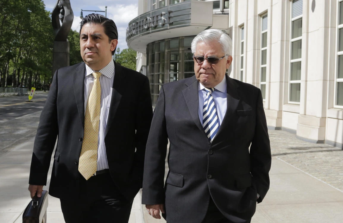Former Guatemalan judge Hector Trujillo, right, leaves Brooklyn federal court after pleading guilty Friday in New York. (AP)