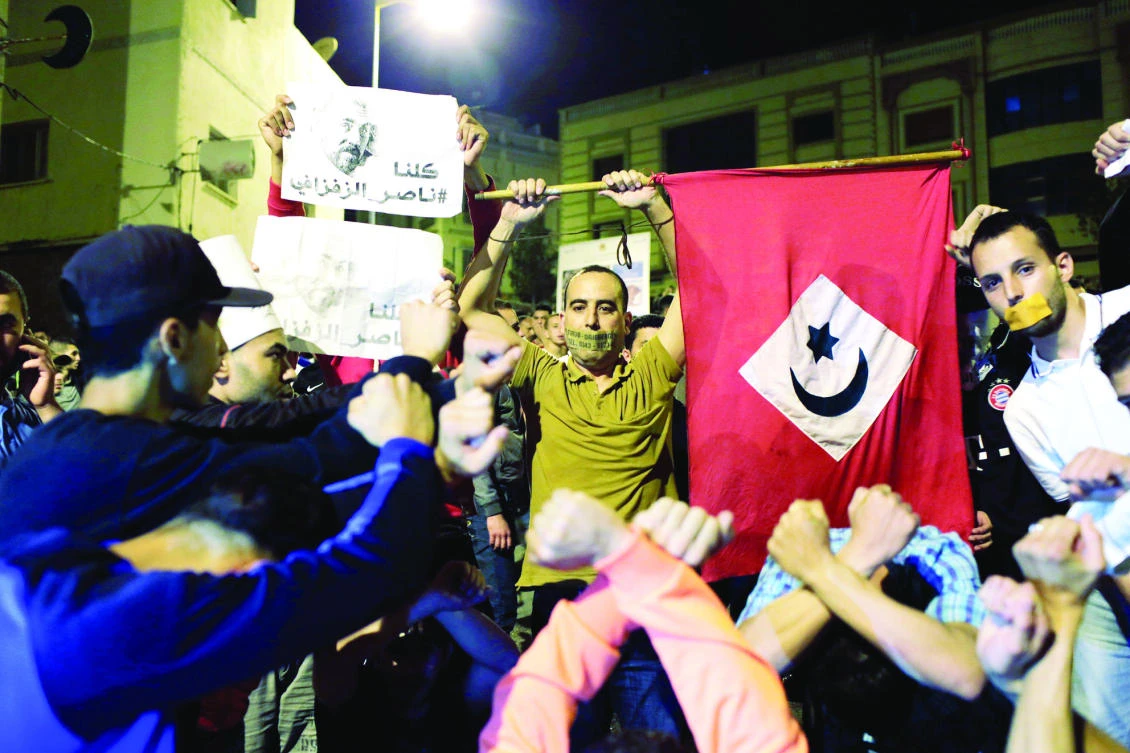 Moroccans take part in a demonstration against official abuses and corruption in the town of Al-Hoceima, Morocco early Saturday. (Reuters)