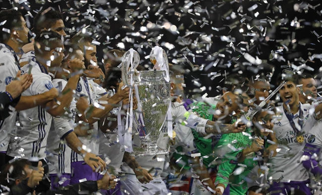 Real Madrid players celebrate at the end of the Champions League soccer final between Juventus and Real Madrid at the Millennium Stadium in Cardiff, Wales, on Saturday. Real won the match 4-1. (AP Photo/Frank Augstein)