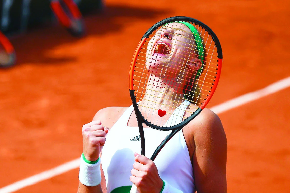 France’s Kristina Mladenovic celebrates after winning her tennis match against Spain’s Garbine Muguruza at the Roland Garros 2017 French Open on Sunday in Paris. (AFP)