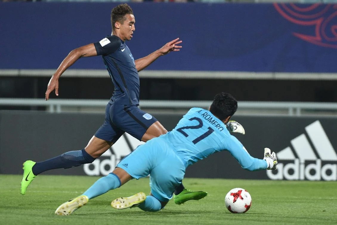 England's forward Dominic Calvert-Lewin and Mexico's goalkeeper Abraham Romero compete for the ball during the U-20 World Cup quarter-final football match between England and Mexico in Cheonan on Sunday. (AFP)