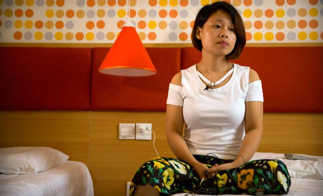 Deng Guilian, the wife of detained Chinese labor activist Hua Haifeng, speaks during an interview in Ganzhou in southeastern China's Jiangxi Province, on Tuesday. (AP Photo/Mark Schiefelbein)