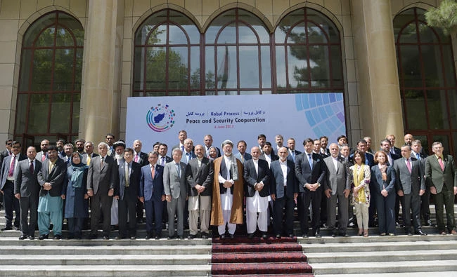 Afghan President Ashraf Ghani, center, with foreign delegates after an international peace conference at the Presidential Palace in Kabul on Tuesday. (AFP)