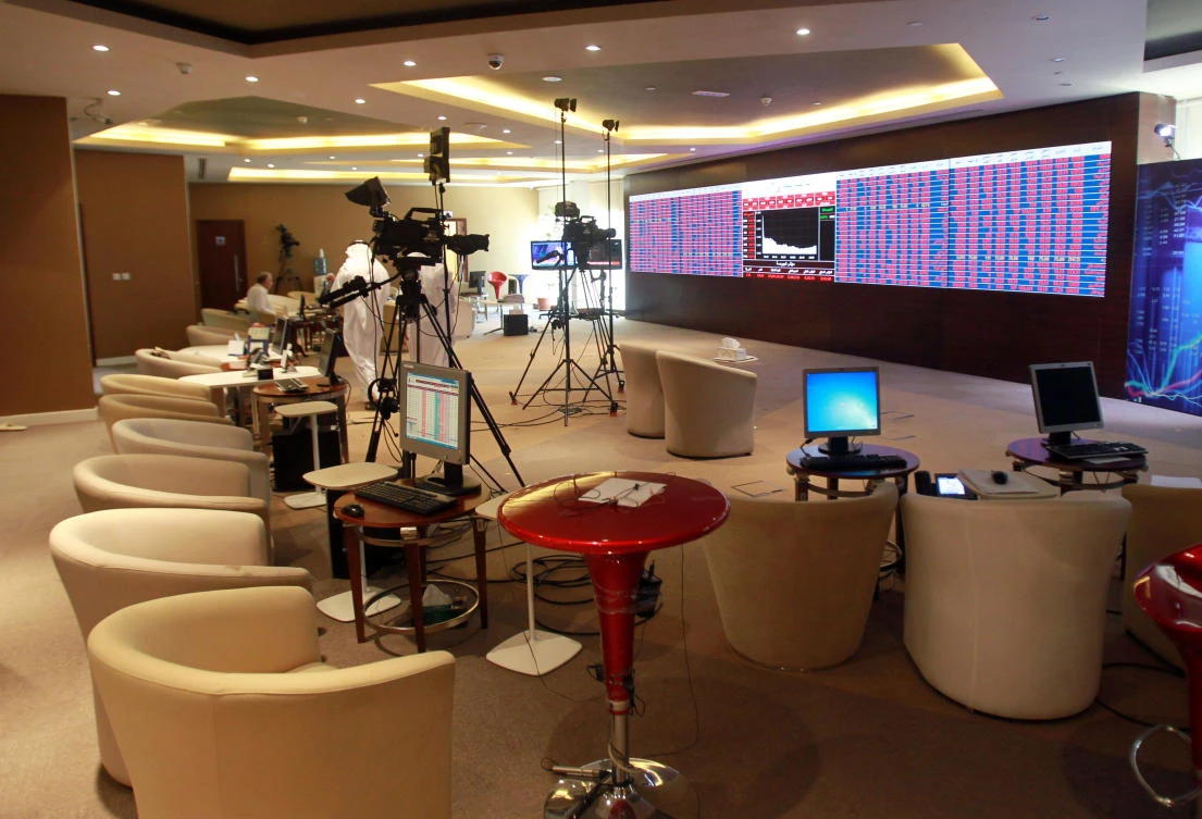 Screens displaying stock information are seen at Qatar Stock Exchange in Doha, Qatar on June 5, 2017. (REUTERS)