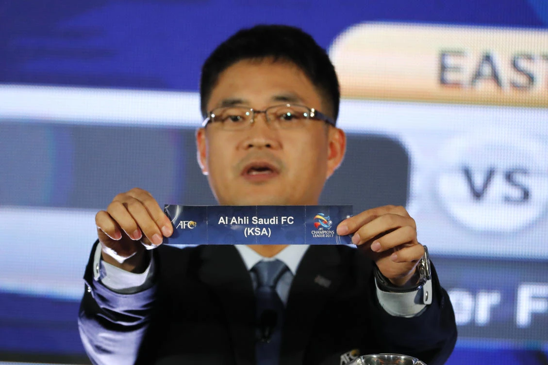 Asian Football Confederation's (AFC) director of the National Team Competition Shin Mangil holds the name card of Al-Ahli Football Club from Saudi Arabia in the draw for the 2017 AFC Champions League Knockout stage in Kuala Lumpur Tuesday. (AP)