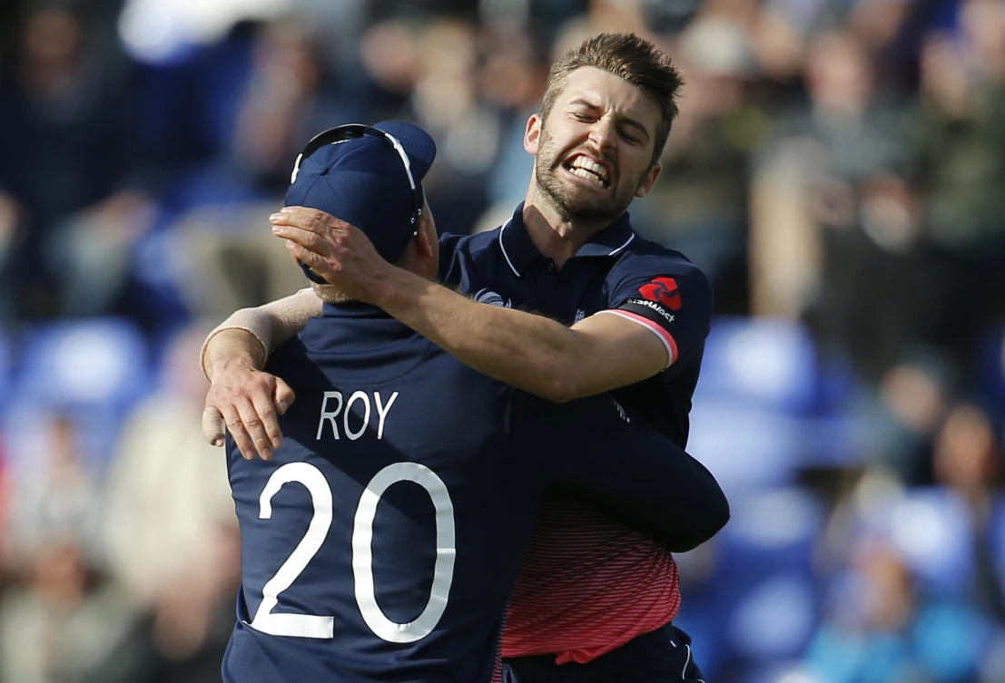 England's Mark Wood celebrates the wicket of New Zealand's Kane Williamson with Jason Roy in the 2017 ICC Champions Trophy Group A match between England and New Zealand on Tuesday. (Reuters)