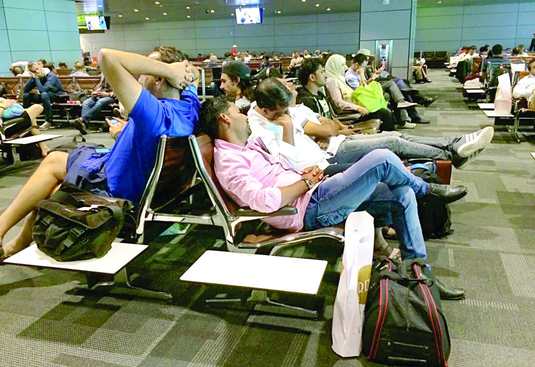 Passengers of canceled flights wait at Hamad International Airport in Doha Tuesday. (AP)
